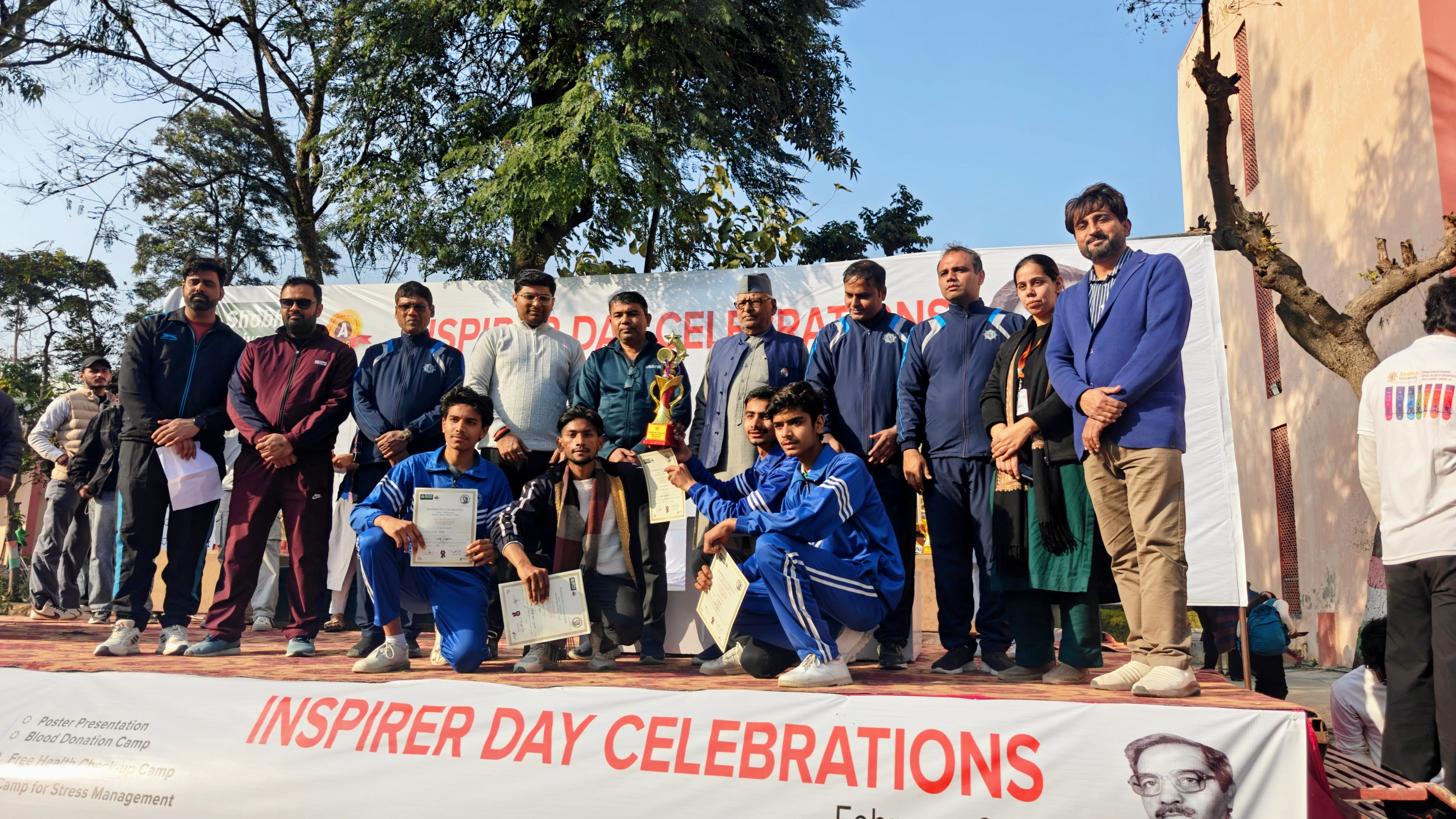 Students receiving certificates and trophy