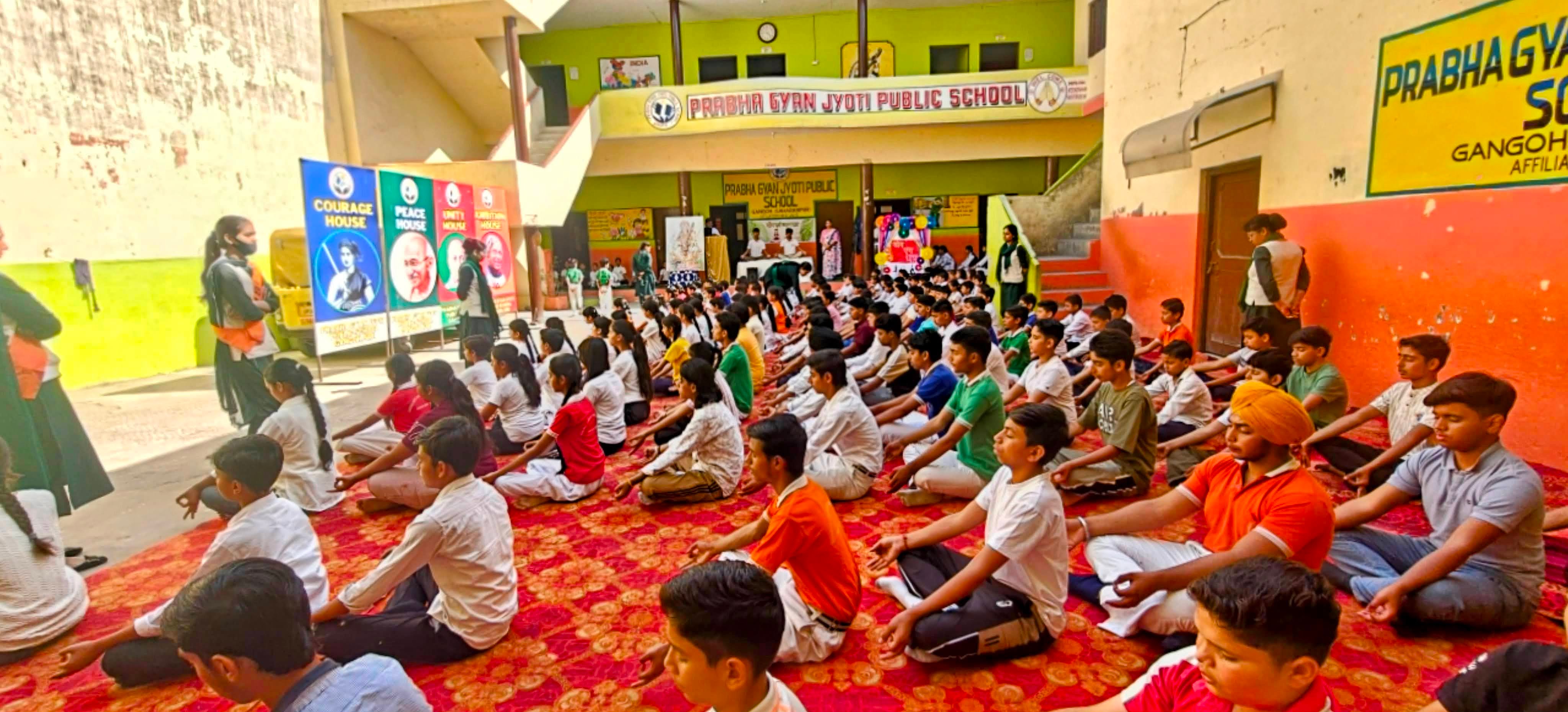 Students practicing yoga during school assembly